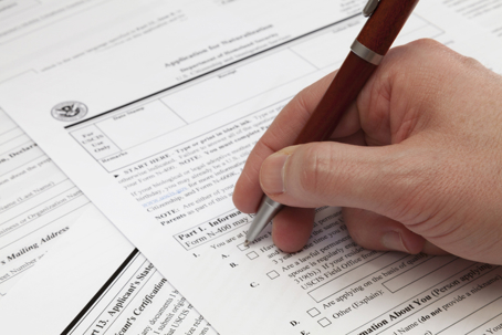 man filling out naturalization application form