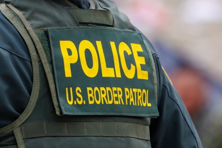 San Diego, California, USA  - May 12 2023: Close up of Border Patrol  patch on uniform at the San Diego, CA and Mexico international border wall after title 42 policy has expired.