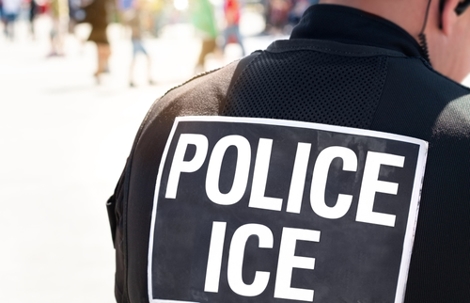 Ice police agent - Officer of Immigration and Customs Enforcement. Close up of POLICE ICE on back of stab proof vest worn by DHS Department of Homeland Security police officer at the scene of incident